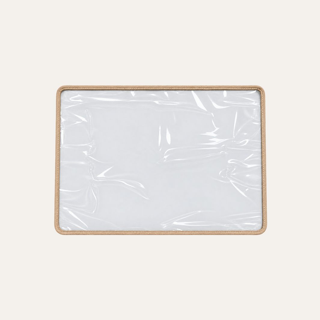 A rectangular clear plastic tray or cover for shampoo chair
