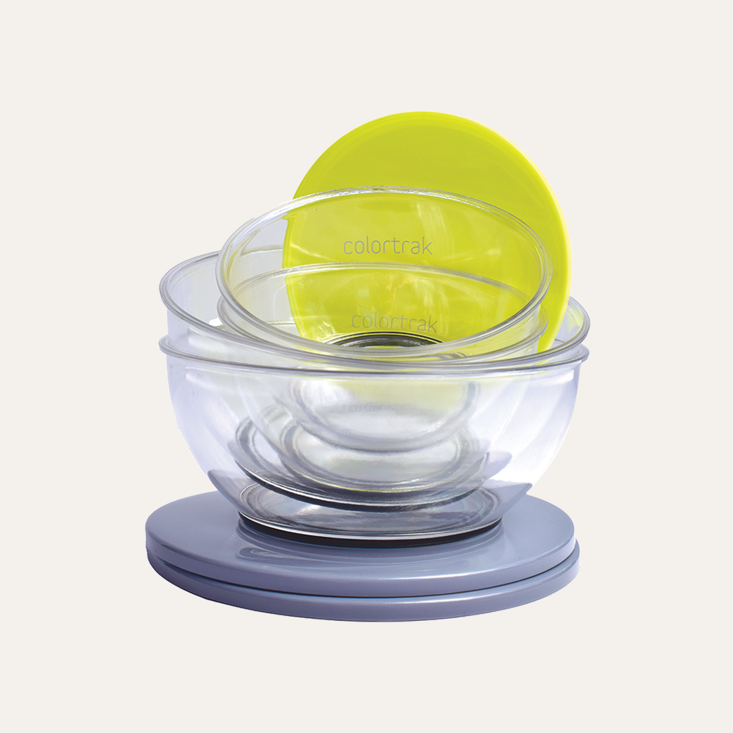 Four clear Ambassador bowls stacked with yellow and gray lids