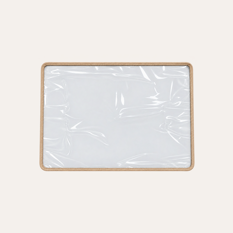 A rectangular clear plastic tray or cover for shampoo chair