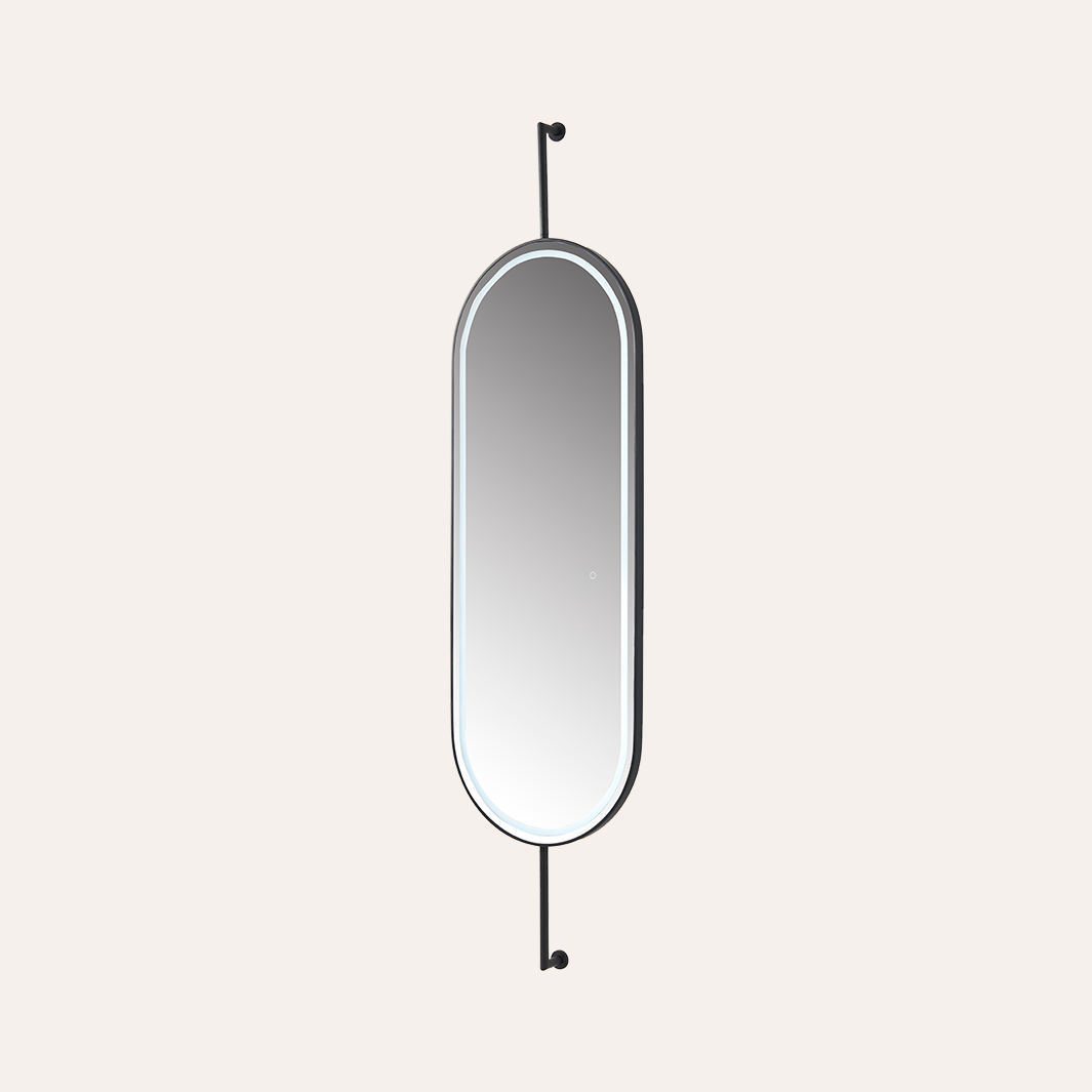 A minimalist wall mirror with an elongated oval shape, featuring a black metal frame and two matching black wall hooks extending from the top and bottom, shown against a solid off-white background.