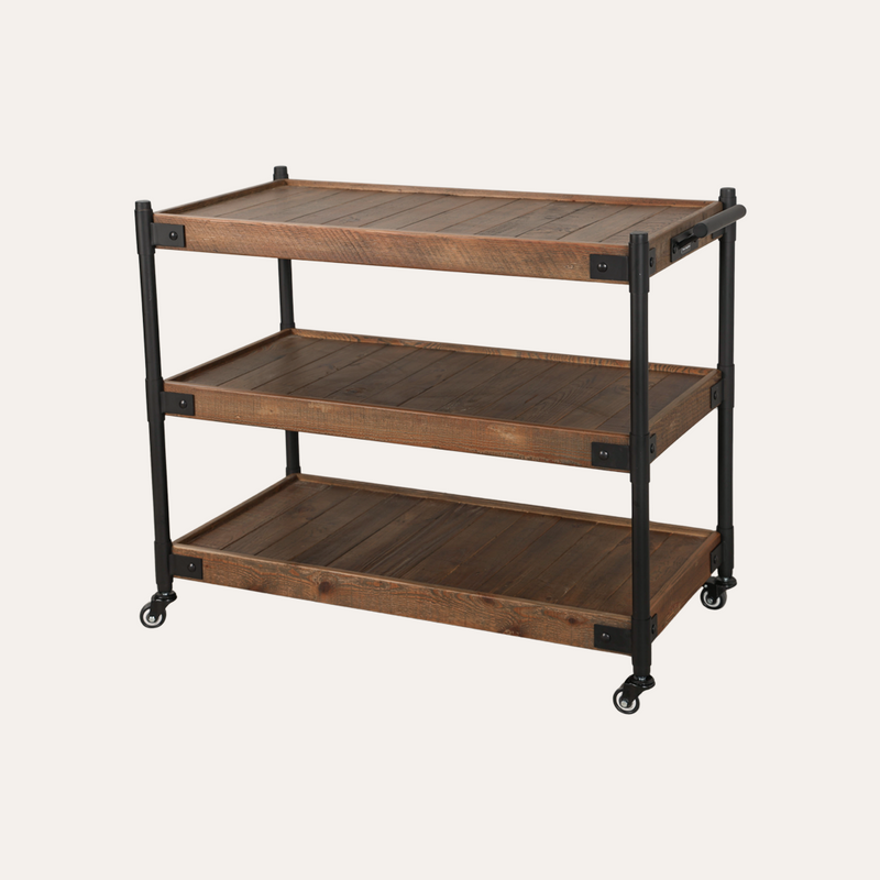 A three-tier rolling salon & barber cart with rustic brown wood shelves and a black metal frame on casters, shown against a solid off-white background.