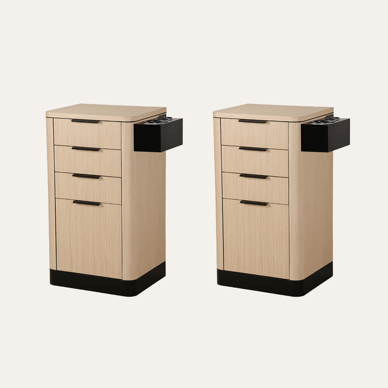 Two matching salon stand cabinets with a light wood grain finish and black accents, including drawer pulls, cup holders, and base trim, shown on a plain light background.